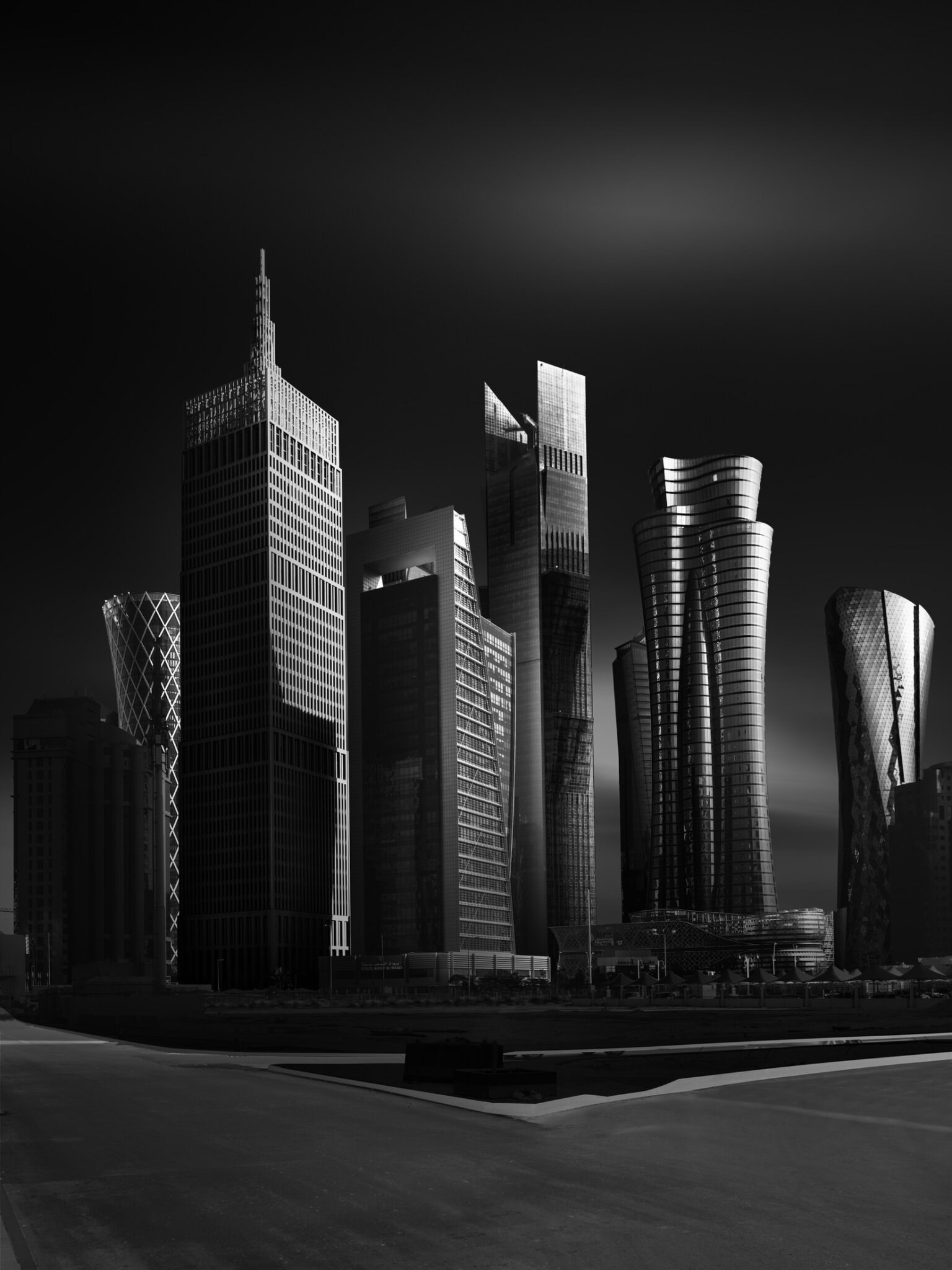 Black and white fine art photograph of the Doha city skyline with sculptural twisted skyscrapers