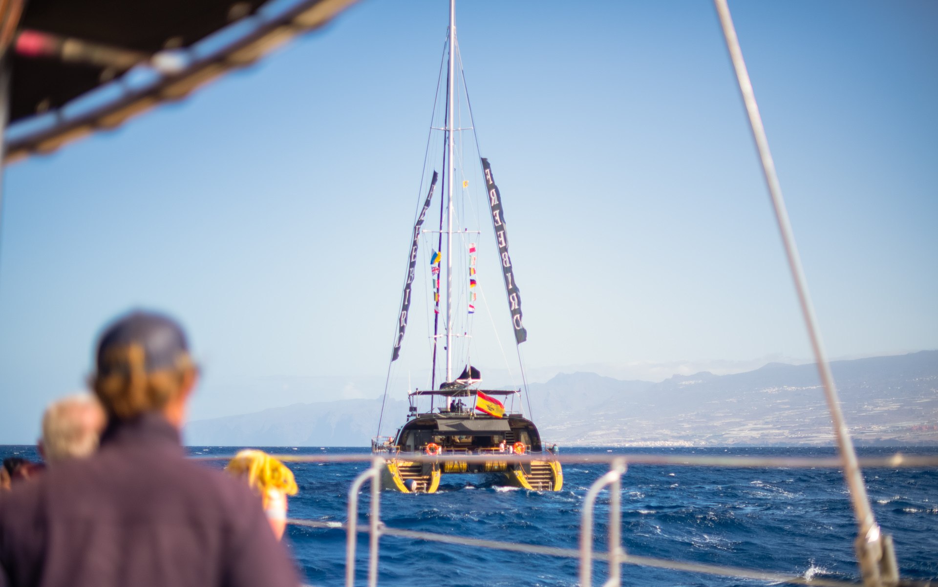 View from a sailing catamaran of a motorboat on the open Atlantic Ocean — destination travel photography